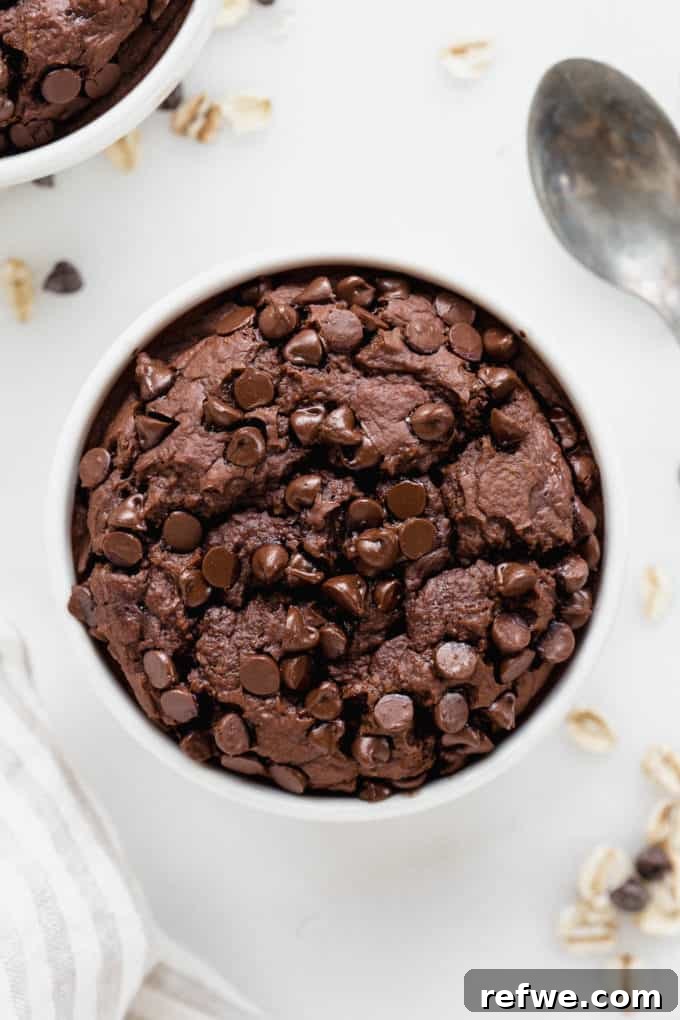 Morning Chocolate Indulgence 8 Freshly baked chocolate baked oats in a white ramekin, adorned with slightly melted chocolate chips on top.