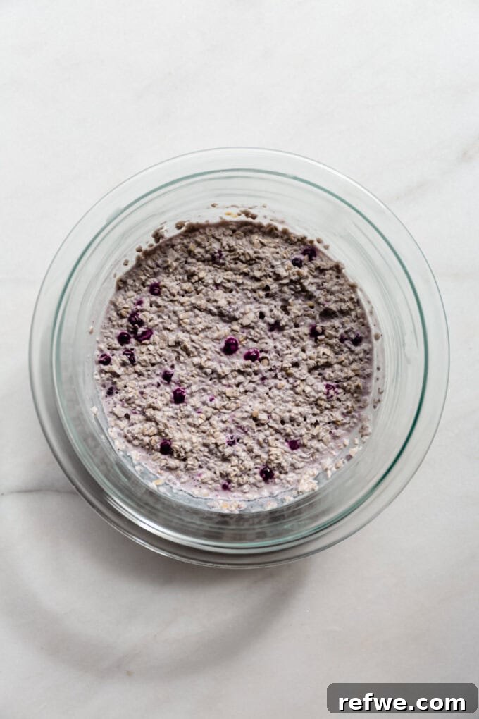 Creamy Blueberry Overnight Oats 8 Creamy blueberry overnight oats in a clear mixing bowl, perfectly set after refrigeration.
