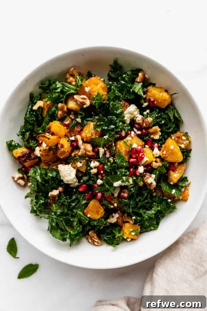 Autumn Roasted Pumpkin Salad 9 A beautifully presented white bowl of roasted pumpkin salad, adorned with a beige napkin on the side, ready for serving.