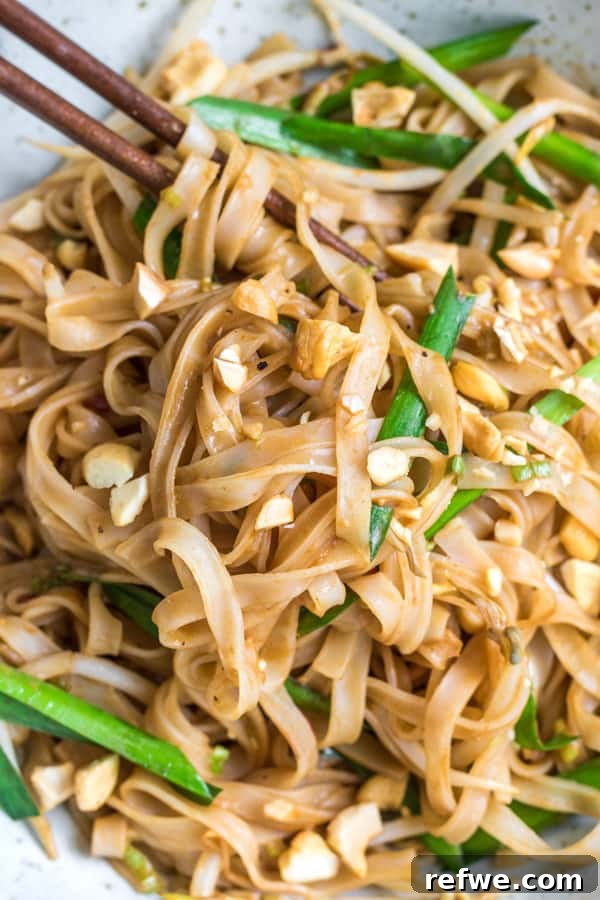 Close-up of Spicy Sichuan Noodles with toppings