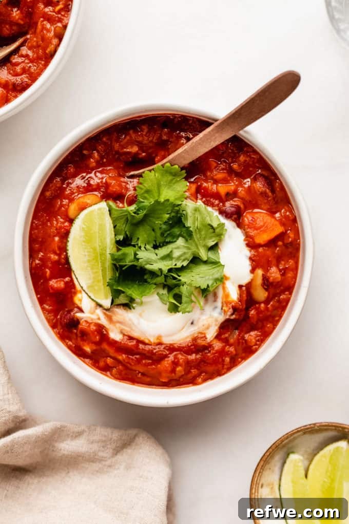 Irresistible Vegan Chili 2 a bowl of vegan chili with sour cream and cilantro on top