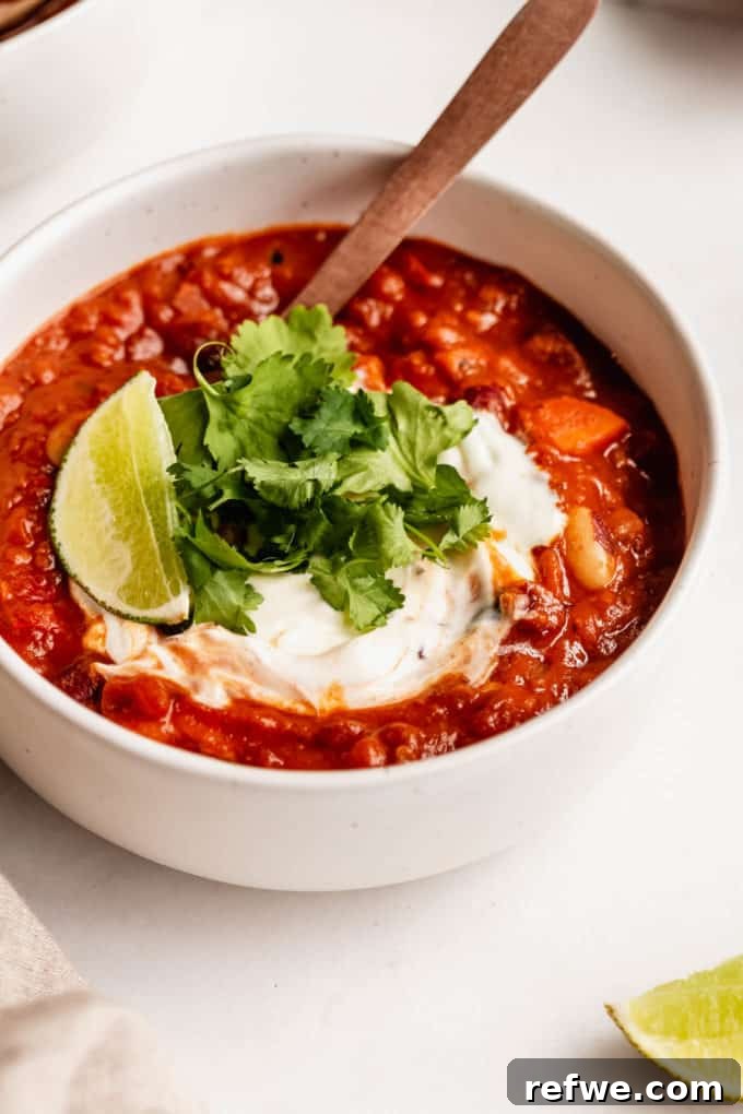 Irresistible Vegan Chili 11 vegan chili topped with cilantro and lime in a white bowl