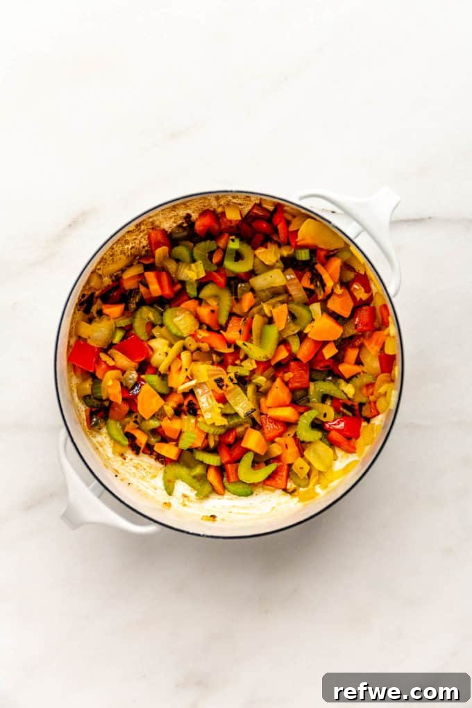 Irresistible Vegan Chili 6 sauteed vegetables in a white pot