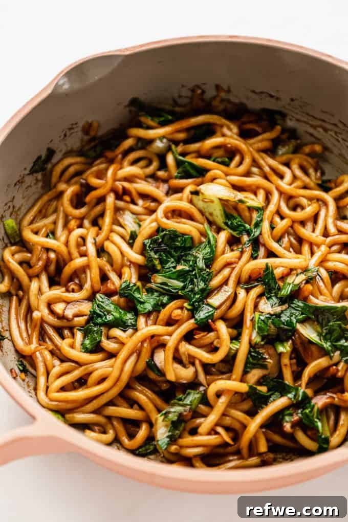Fast and Simple Yaki Udon Stir Fry 8 The finished Yaki Udon stir-fry, noodles and vegetables glistening with savory sauce, cooked to perfection in a pan, ready to be served.