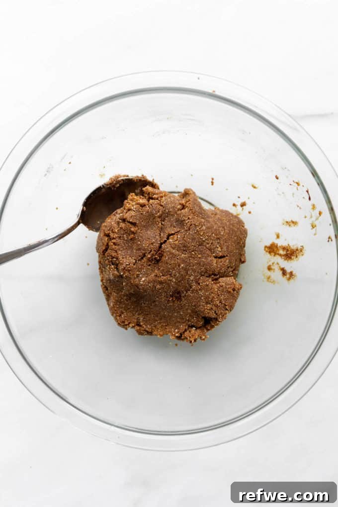 Holiday Gingerbread Dough Bites 6 Perfectly mixed gingerbread truffle dough resting in a clear mixing bowl, showcasing its ideal rollable texture.