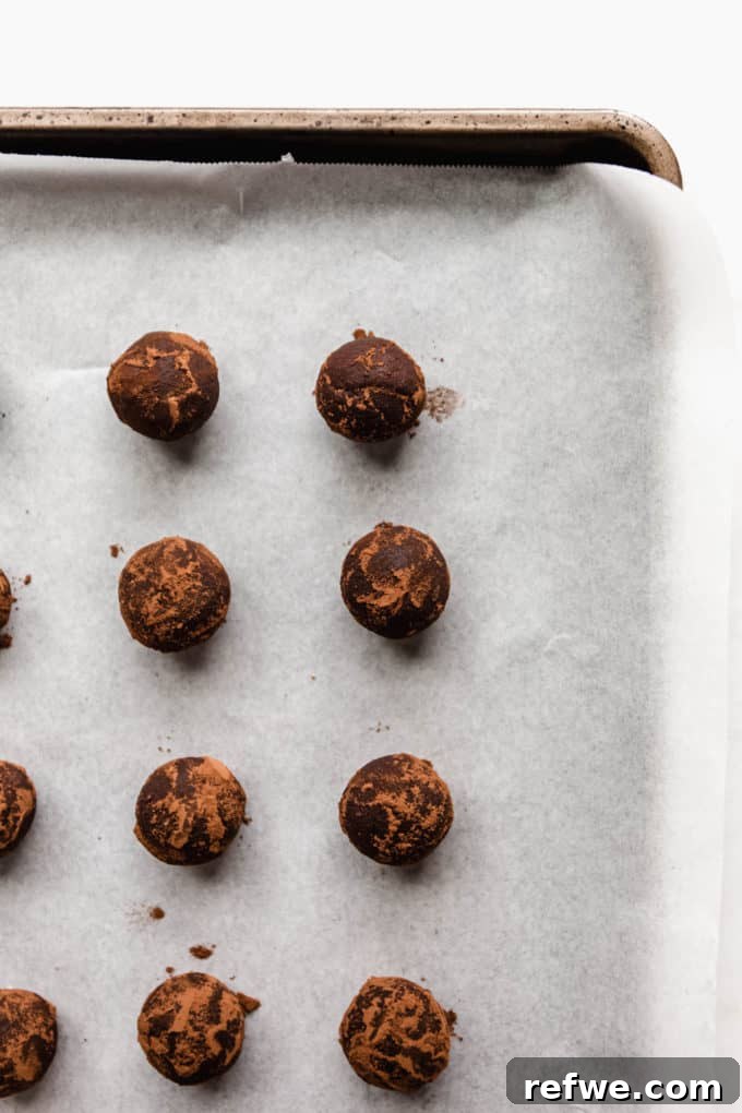 Holiday Gingerbread Dough Bites 7 Freshly rolled gingerbread truffles arranged neatly on a baking sheet, ready for chilling or optional coating.