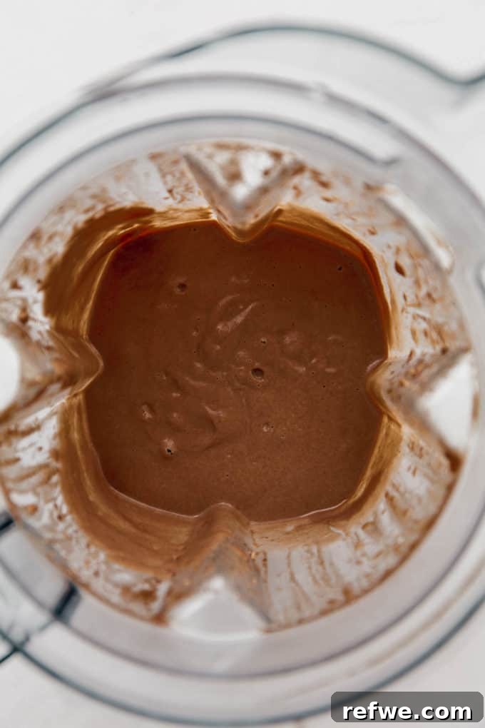 Velvet Mint Chocolate Pudding 5 The smooth, creamy mint chocolate pudding base in a blender container, awaiting the melted chocolate.