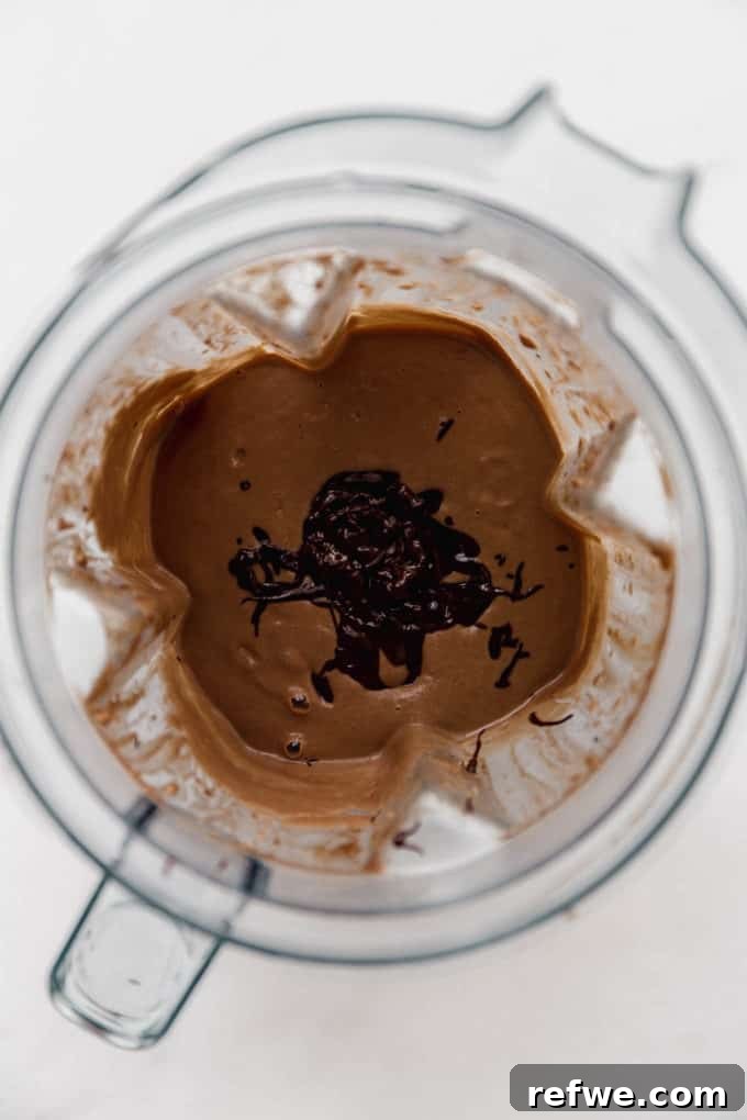 Velvet Mint Chocolate Pudding 8 The luxurious blend of chocolate pudding and freshly added melted dark chocolate swirling together in the blender, creating a decadent consistency.