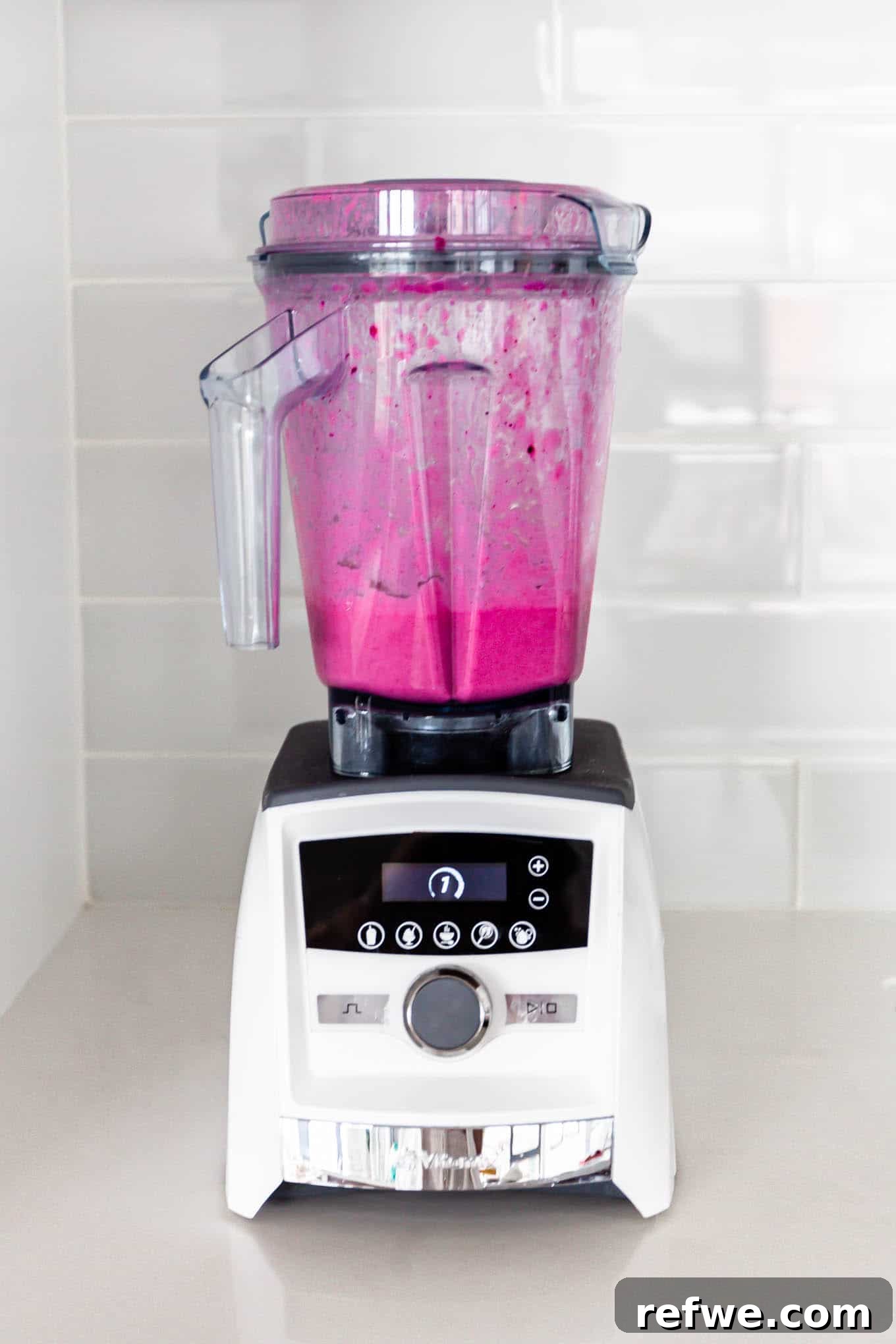 Pitaya Paradise Smoothie 5 The dragon fruit smoothie mixture being blended in a high-speed blender, showing its smooth, pink consistency.