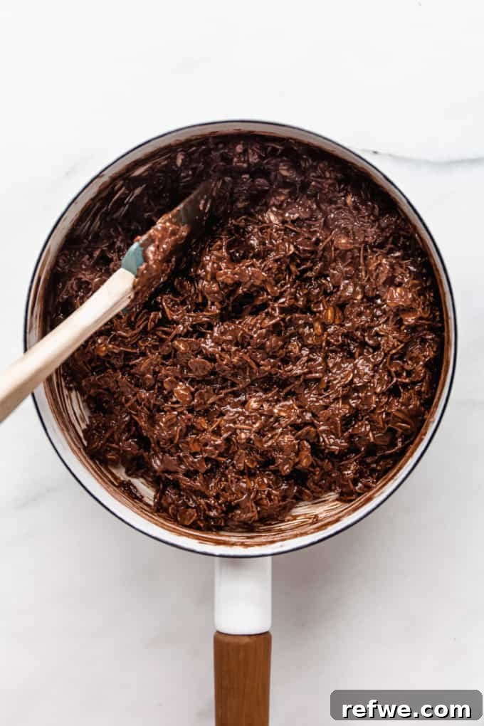 Chocolate Coconut No Bake Dream Bars 6 The rich chocolate coconut bar batter fills a white pot, a delicious mix of wholesome ingredients.