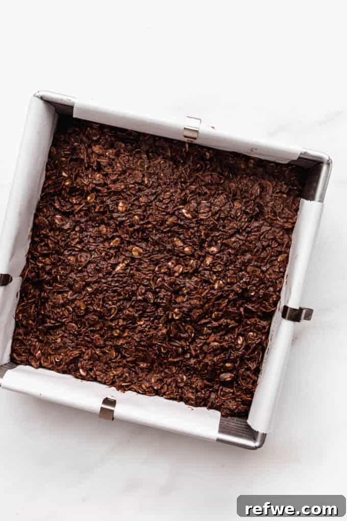 Chocolate Coconut No Bake Dream Bars 8 A pan full of un-cut chocolate coconut bars, perfectly set and ready to be sliced.