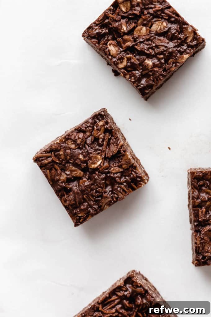 Chocolate Coconut No Bake Dream Bars 9 Perfectly cut no-bake chocolate coconut bars arranged on a marble board, ready to be served.