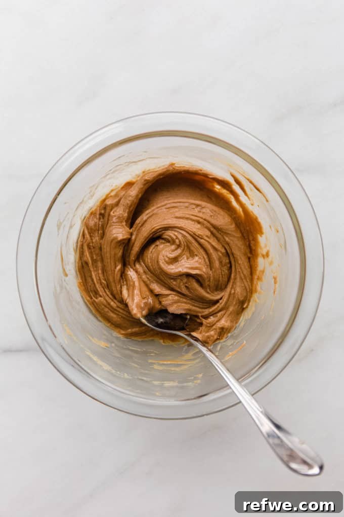 Funfetti Protein Bites 4 Smooth, golden cashew butter swirled alone in a mixing bowl, showcasing its creamy texture.