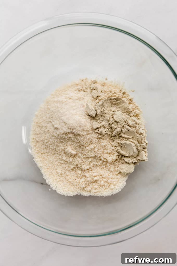 Funfetti Protein Bites 5 Almond flour and protein powder, a perfect blend of dry ingredients, patiently waiting in a mixing bowl.