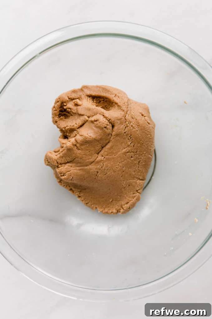 Funfetti Protein Bites 7 A perfectly blended dough of almond flour and cashew butter, forming beautifully in a clear mixing bowl, ready for additions.