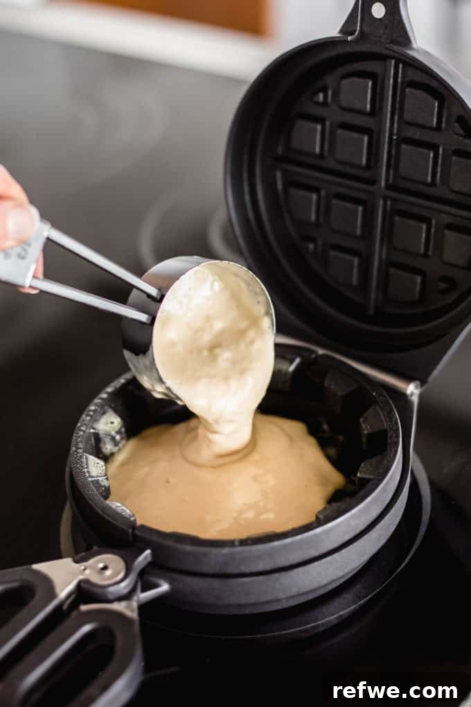 Fluffy Almond Flour Waffles 7 Thick waffle batter being carefully spooned or poured into the preheated and greased waffle press.