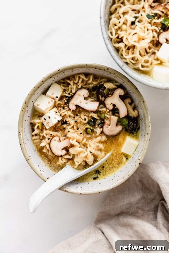 Whip Up Miso Ramen in 15 Minutes 11 A close-up of a vibrant bowl of miso ramen featuring perfectly cooked noodles, shiitake mushrooms, and fresh green garnishes.