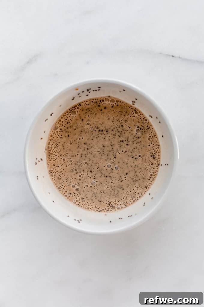 Decadent Tiramisu Chia Pudding 5 Espresso, chia seeds, and coconut milk combined in a white bowl for the coffee layer.