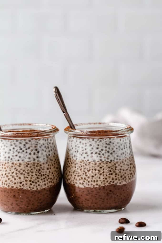 Decadent Tiramisu Chia Pudding 10 Two elegantly presented cups of Tiramisu Chia Pudding, showcasing the layers and toppings.