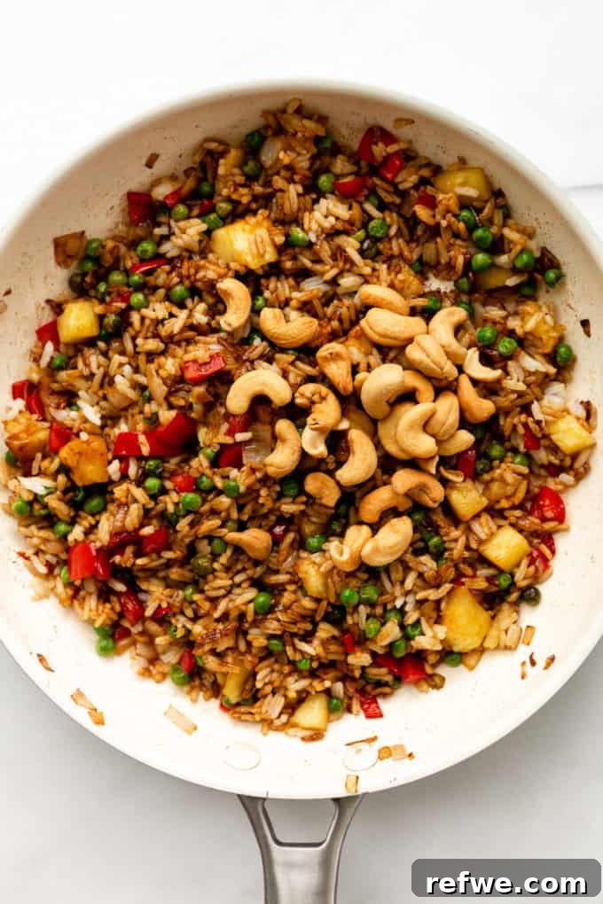 Pineapple Paradise Fried Rice 14 Delectable fried rice generously topped with roasted cashews, still in the pan, ready to be served.