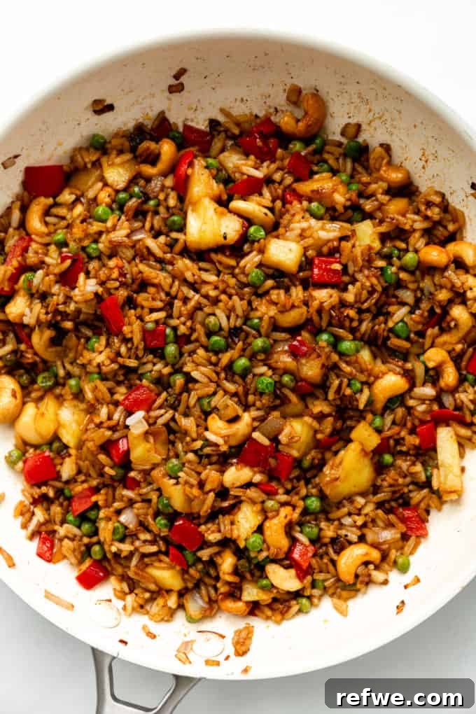 Pineapple Paradise Fried Rice 15 A close-up view of a pan brimming with beautifully cooked pineapple fried rice, showcasing its vibrant colors and textures.