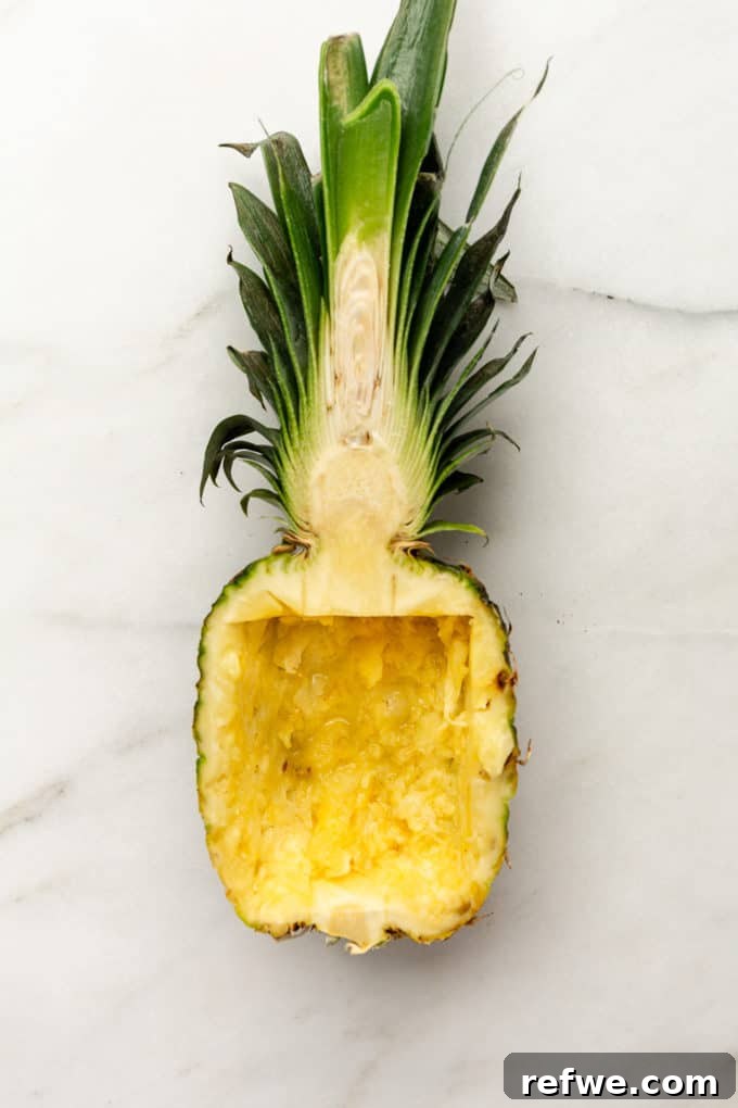 Pineapple Paradise Fried Rice 9 A perfectly hollowed-out pineapple half, ready to be filled with the delicious fried rice.
