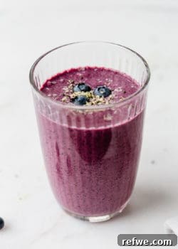 A blueberry spinach smoothie in a glass