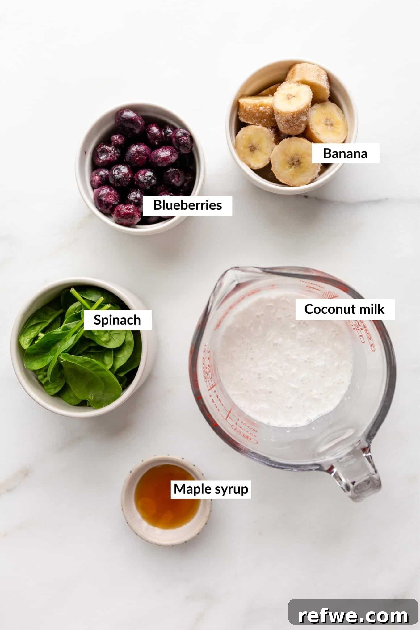 Vibrant Berry Spinach Blend 3 Ingredients for blueberry spinach smoothie laid out on a surface.