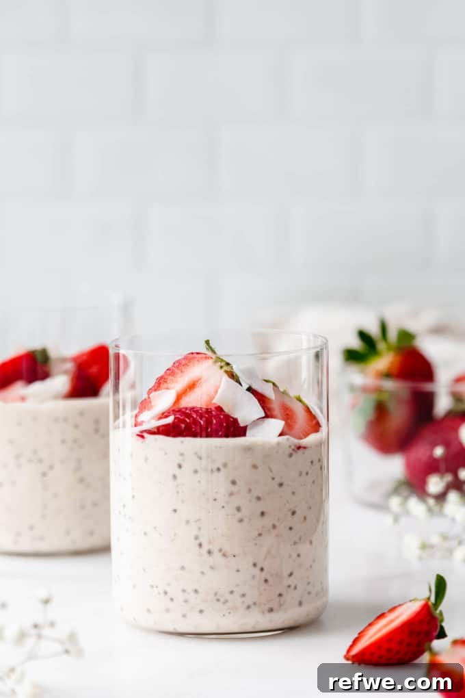 Power Protein Overnight Oats 9 Two cups of protein overnight oats, beautifully garnished with fresh strawberries and coconut flakes.