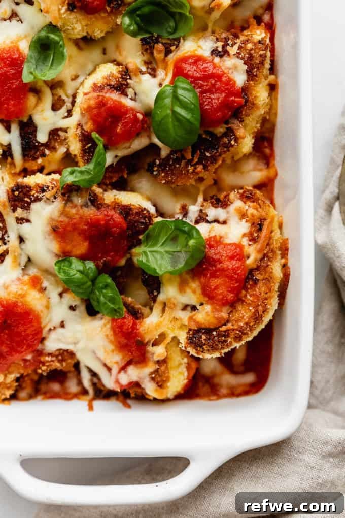 Golden Cauliflower Parmesan Bake 2 Golden brown Cauliflower Parmesan topped with fresh green basil leaves