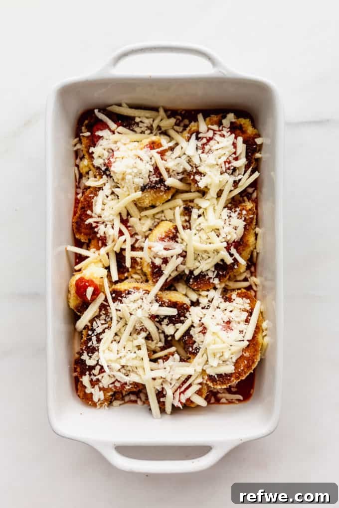Golden Cauliflower Parmesan Bake 6 Cauliflower in a white baking dish topped with shredded mozzarella cheese