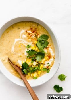 A bowl of vegan corn chowder topped with corn and cilantro