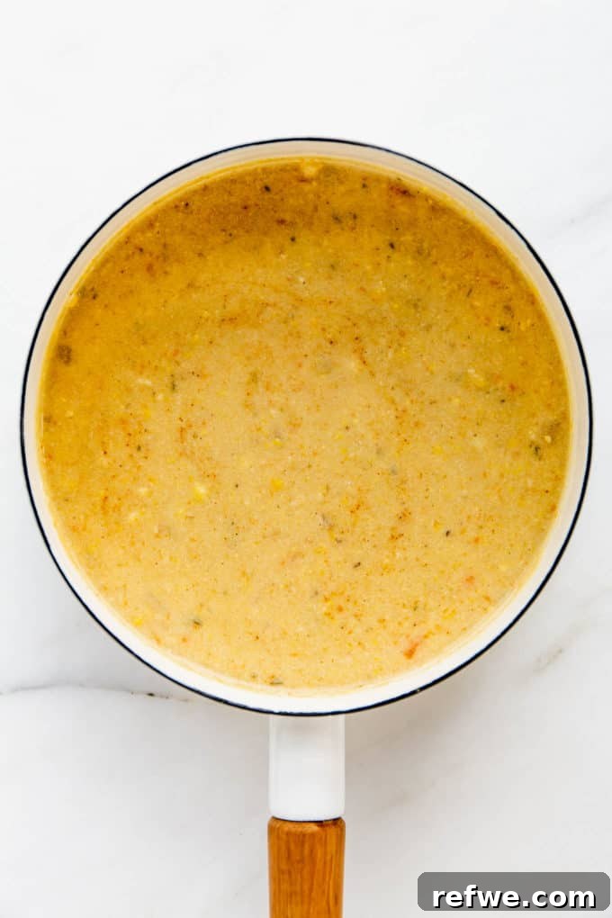 Creamy Vegan Corn Chowder 8 A white pot filled with creamy vegan corn chowder, ready to be served