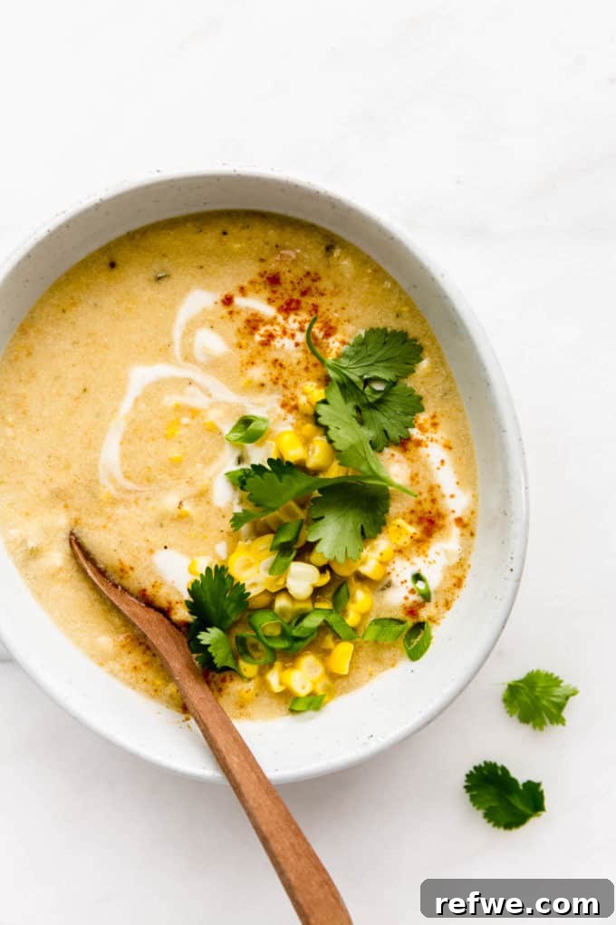 Creamy Vegan Corn Chowder 9 A bowl of vegan corn chowder topped with fresh corn kernels and cilantro, ready to eat