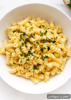 A bowl of lemon fusilli pasta topped with parsley