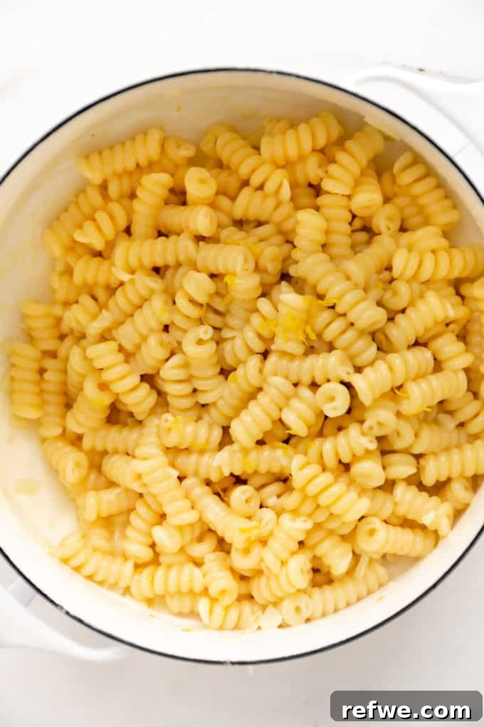 Zesty Lemon Garlic Pasta 9 Creamy lemon pasta glistening in a white pot, indicating the perfect emulsified sauce texture