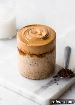 a cup of coffee overnight oats topped with a whipped coffee cream