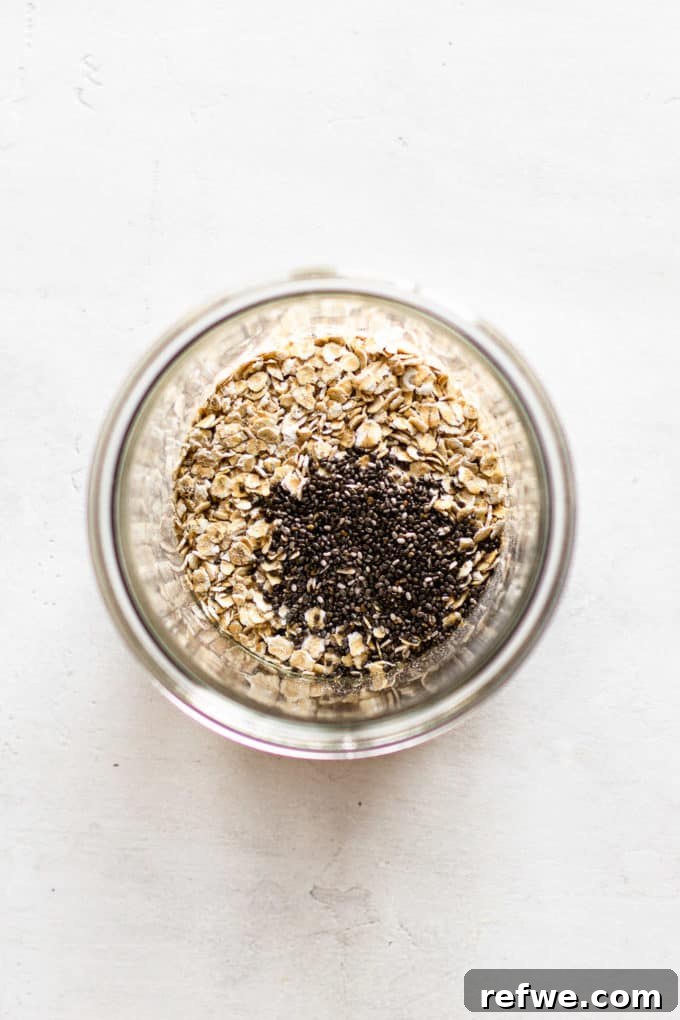 Java Overnight Oats 4 Dry ingredients, including oats and chia seeds, measured out and placed in a clear cup, ready for the liquid additions.