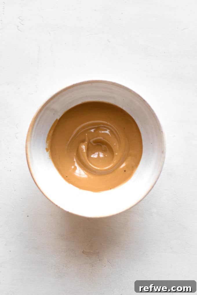 Java Overnight Oats 9 A close-up shot of creamy, whipped Dalgona coffee cream in a bowl, showcasing its airy and enticing texture.