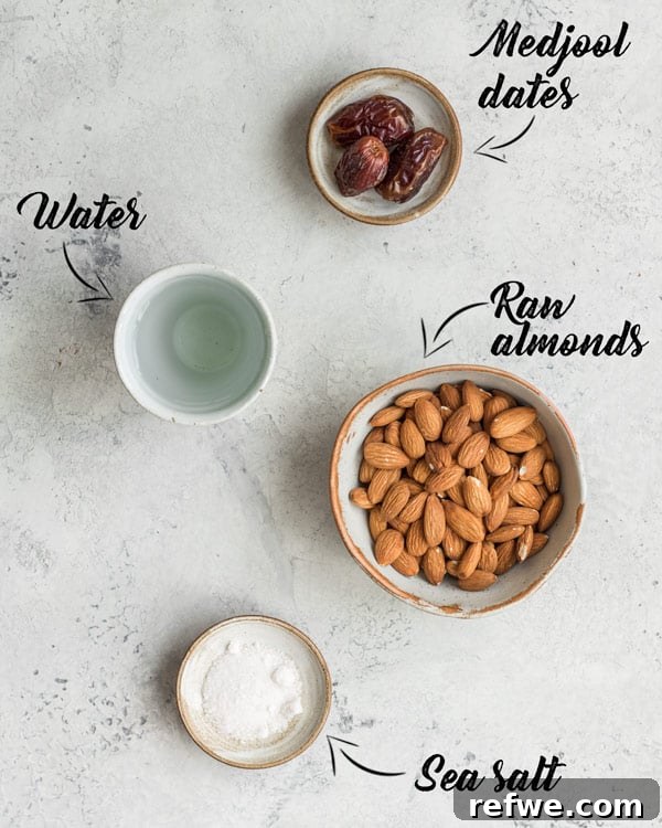 Homemade Almond Milk Freshly Made Freshly made homemade almond milk in a glass bottle with raw almonds scattered around