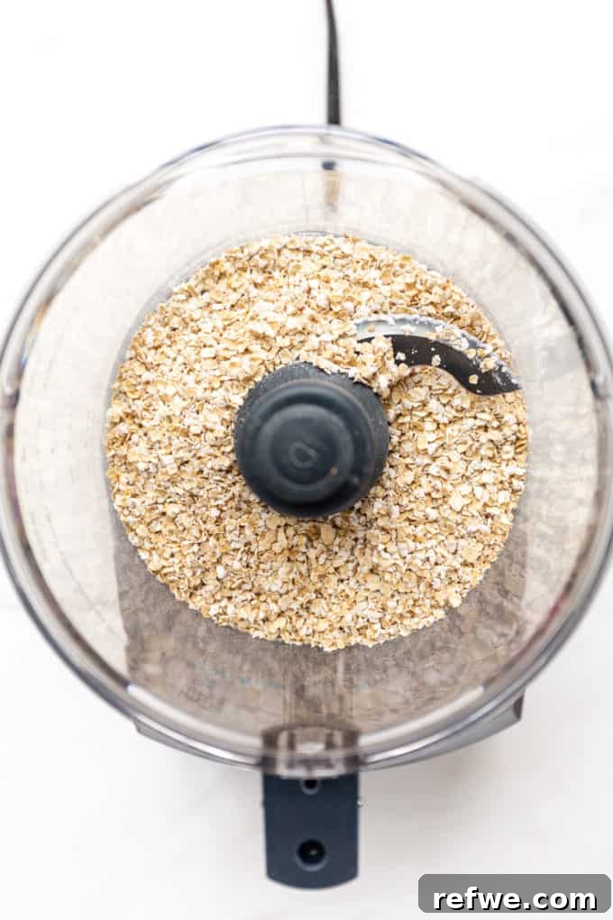 Wholesome Oat Flapjack Feast 3 Rolled oats being added to a food processor for grinding into flour