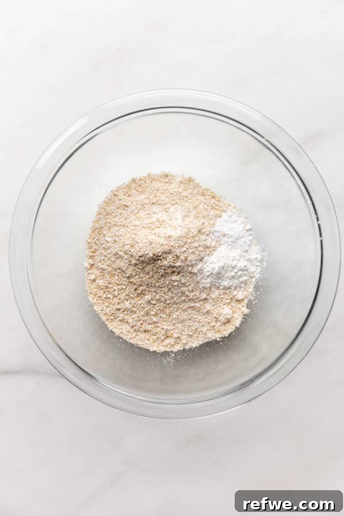 Wholesome Oat Flapjack Feast 5 Dry ingredients: oat flour and baking powder mixed in a clear bowl