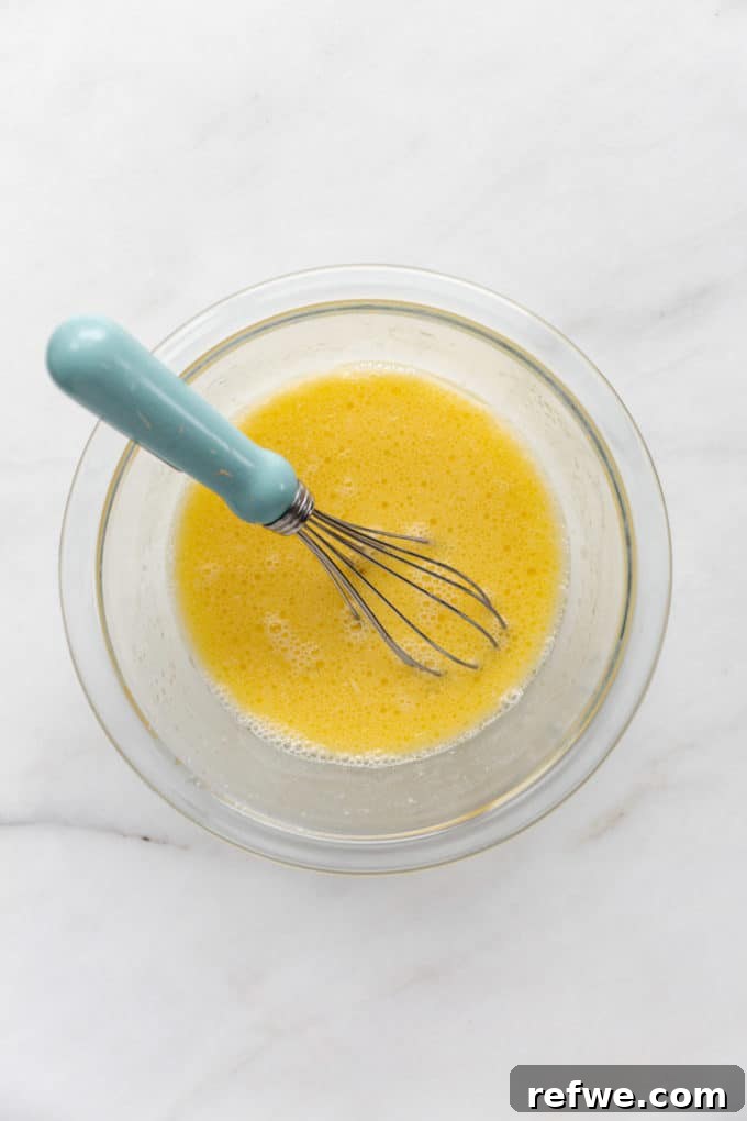 Wholesome Oat Flapjack Feast 6 Whisked eggs and other wet ingredients in a separate bowl