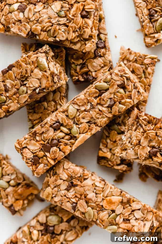 Wholesome Energy Muesli Bars 11 A stack of golden brown muesli bars, showcasing their delicious and wholesome appearance, ready to be enjoyed.
