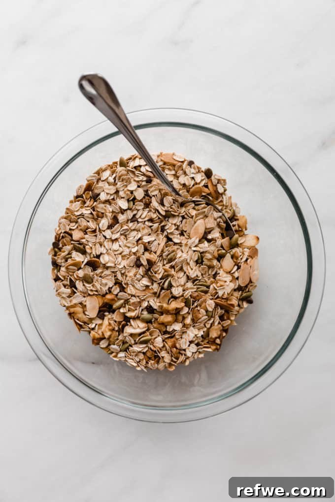 Wholesome Energy Muesli Bars 4 The fully mixed dry muesli ingredients, showcasing a rustic blend of grains, nuts, and seeds in a bowl.