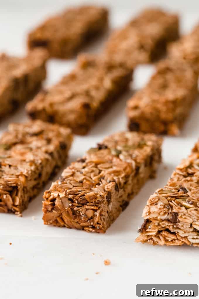 Wholesome Energy Muesli Bars 9 Evenly sliced muesli bars laid out on a cutting board, demonstrating their uniform texture and readiness to eat.