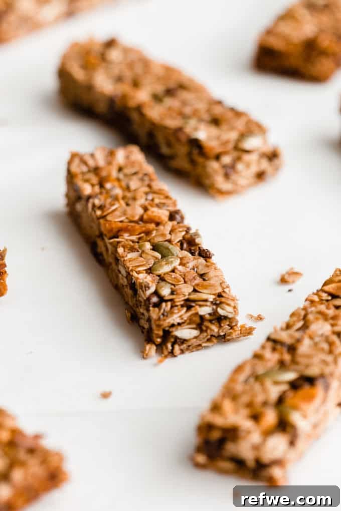 Wholesome Energy Muesli Bars 10 A close-up of perfectly cut muesli bars arranged neatly on parchment paper, highlighting their homemade appeal.