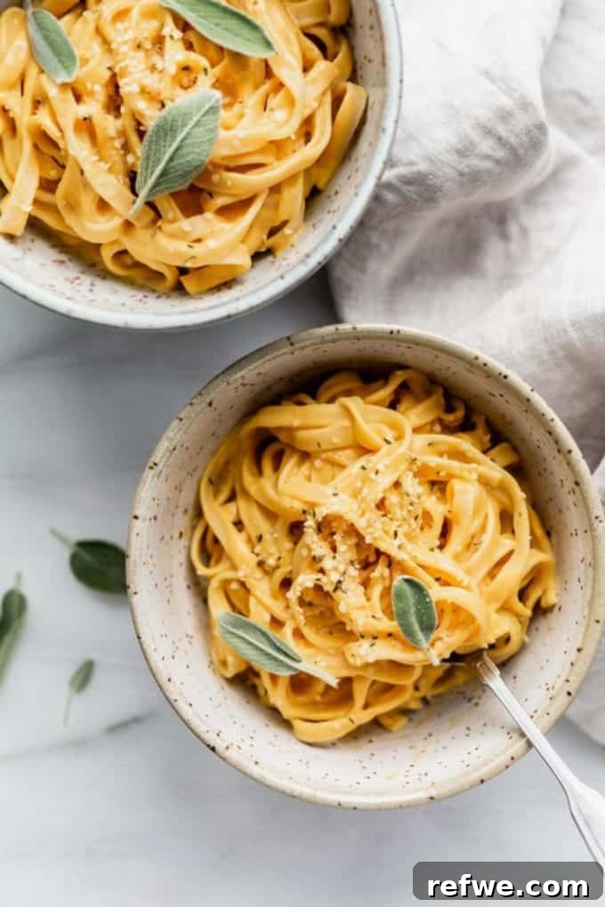 31 Irresistible Vegan Pasta Dishes 9 Two cozy bowls of linguine adorned with creamy pumpkin Alfredo sauce and fresh sage leaves.