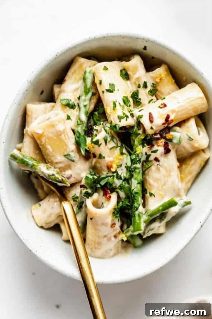 31 Irresistible Vegan Pasta Dishes 7 Rigatoni pasta generously topped with tender asparagus spears and fresh parsley, creating a vibrant and fresh dish.
