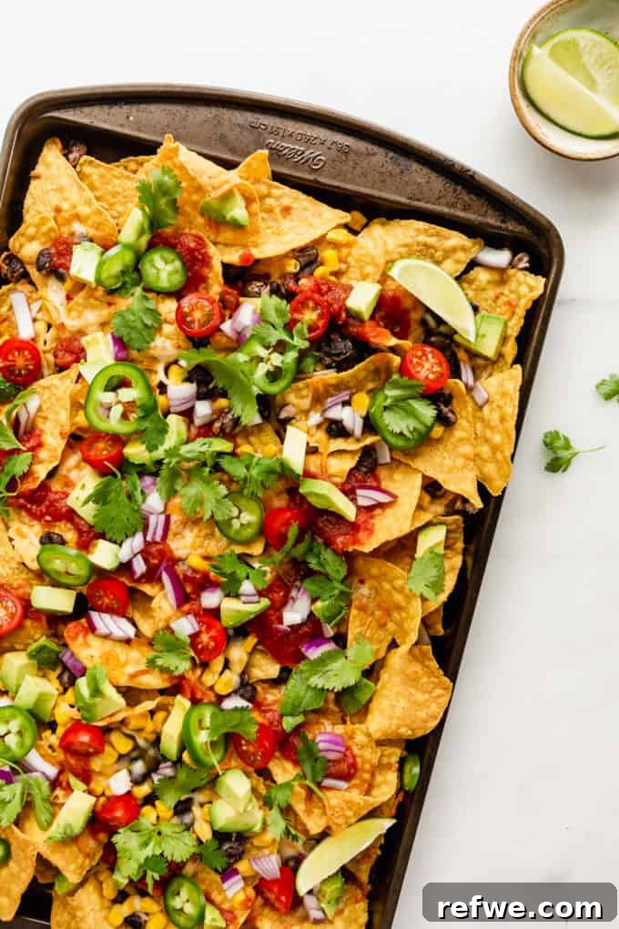 Irresistible Vegetarian Nachos 8 Close-up of vegetarian nachos garnished with fresh cilantro, ready to be served.